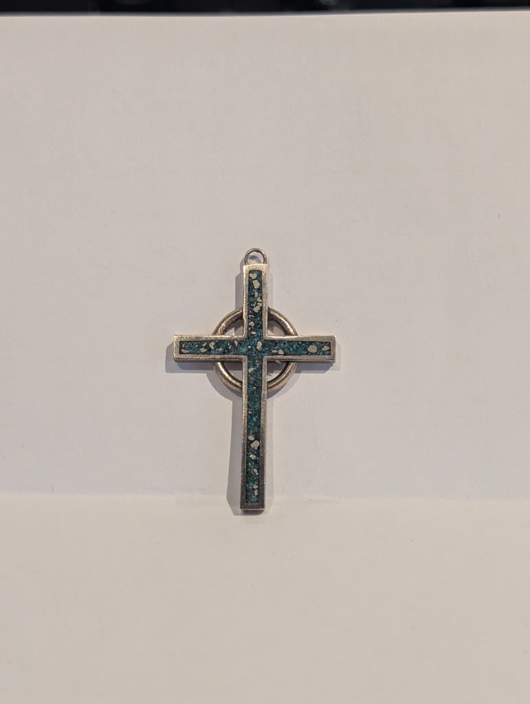 Top-down view of the actual FaithSmith Celtic Cross pendant with turquoise and pearl inlay